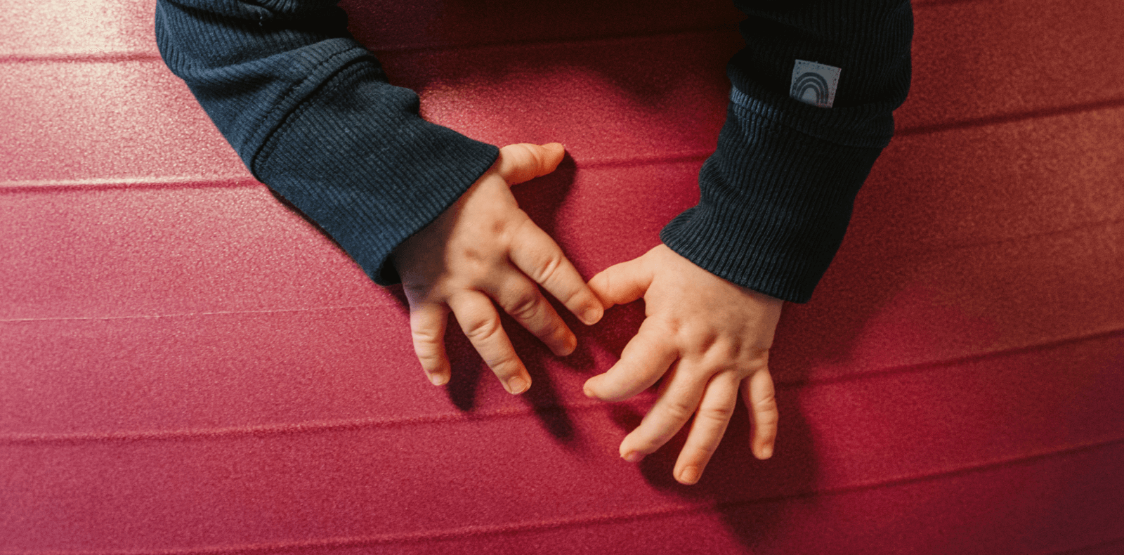 dětské ručičky na červeném míči